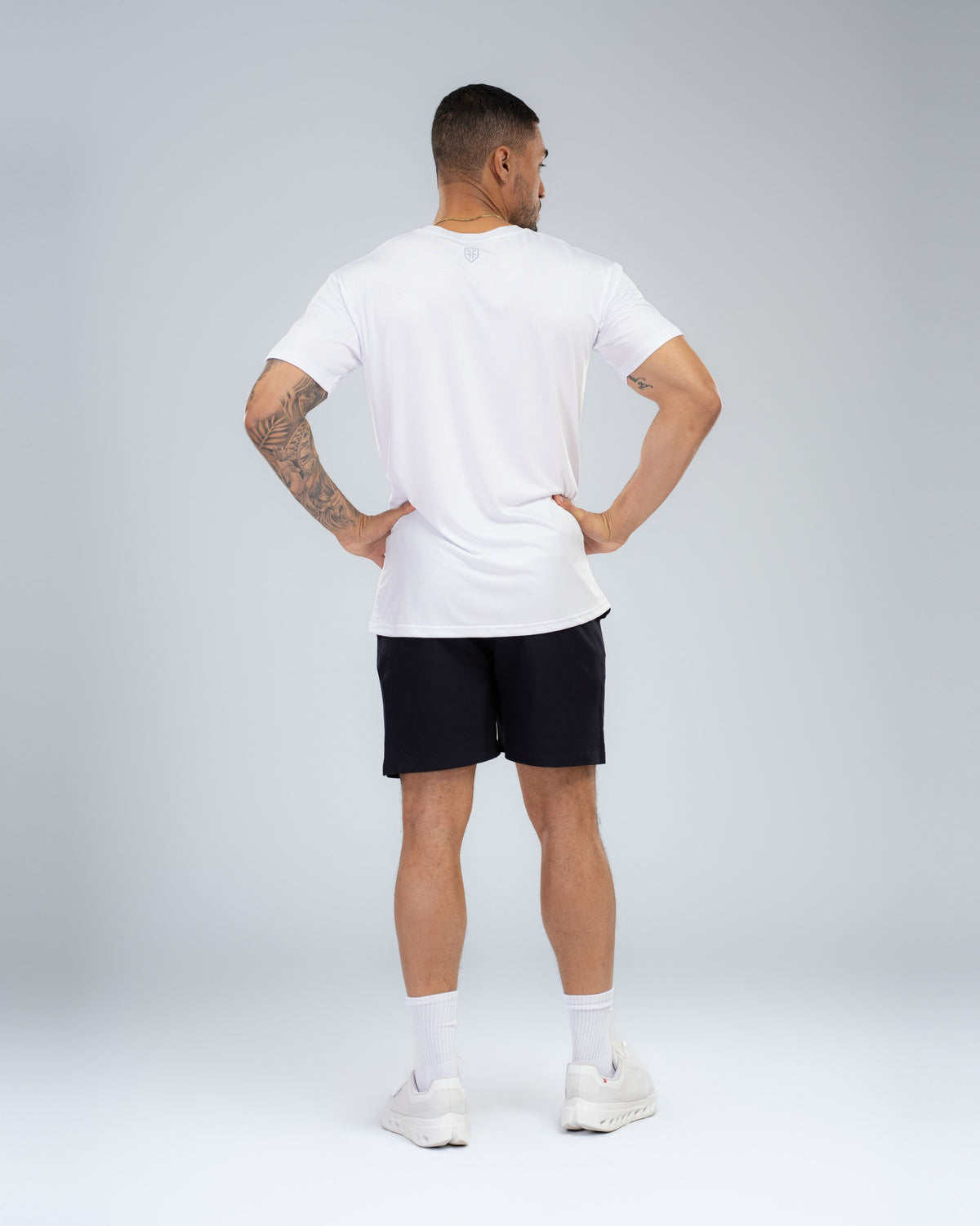 Apex Tech Tee in White, full-length back on model